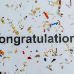 congratulations text on white surface with confetti